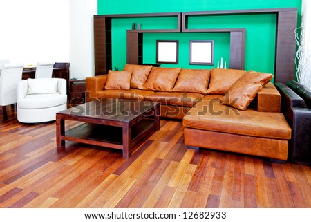 Green living room with brown leather sofa
