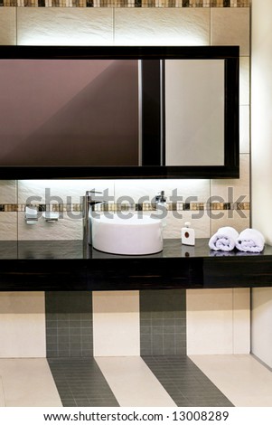 Luxury bathroom with modern basin and big mirror