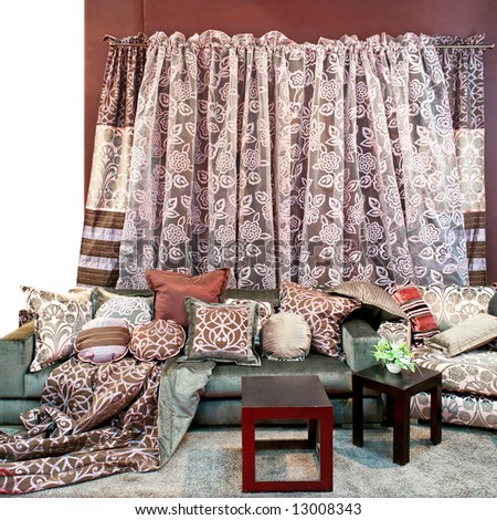 Interior with bunch of pillows and floral curtains