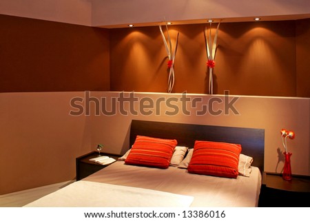 Contemporary brown bedroom with double bed and pillows