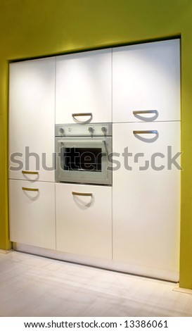 Electric oven in modern white kitchen cabinet