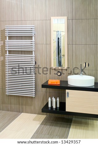 Bathroom with round basin and towels heater