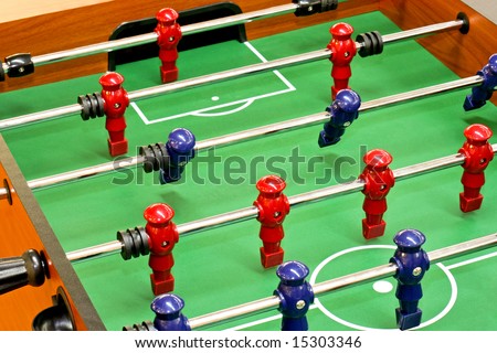 Tabletop foosball game with red and blue figures