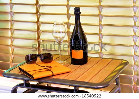 Champagne bottle and glass on small table
