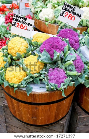 Orange and purple cauliflowers in wooden buckets