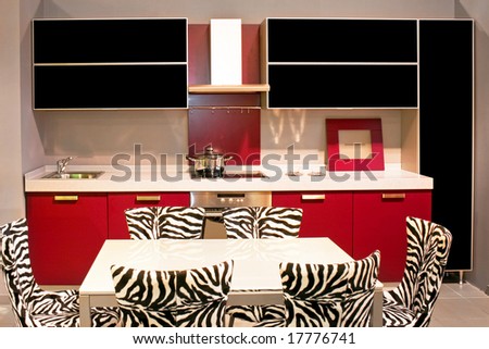 Small modern kitchen in purple with zebra chairs
