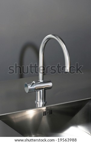 Close up shot of faucet and stainless sink