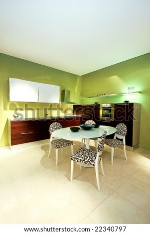Interior shot of green kitchen with table