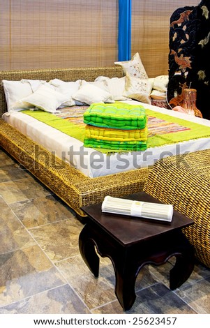 Interior of oriental style bedroom with rattan furniture