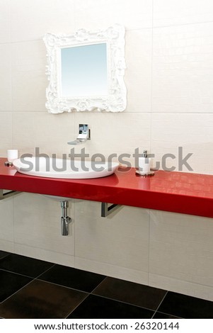 Interior of modern bathroom with red details
