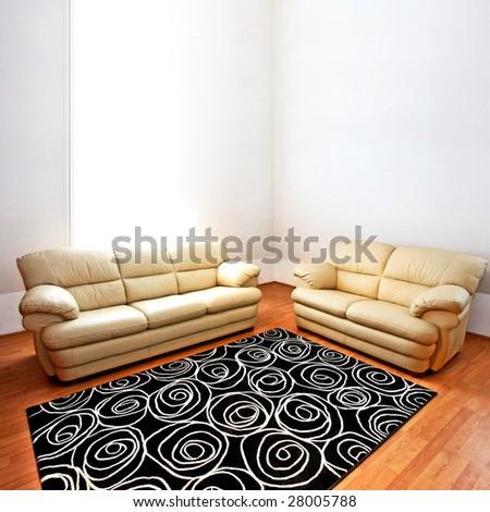 Two beige leather sofas in living room