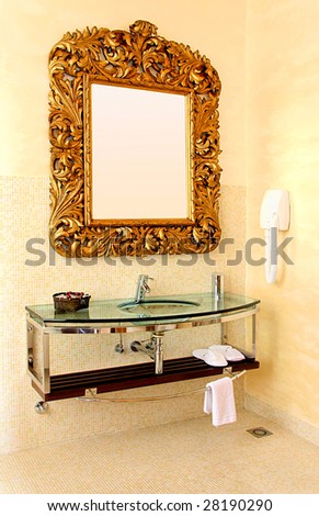 Big gold rustic mirror at contemporary bathroom