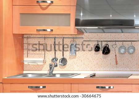 Detail of compact kitchen in light wood
