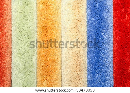 Color samples of bushy wool carpet rolls