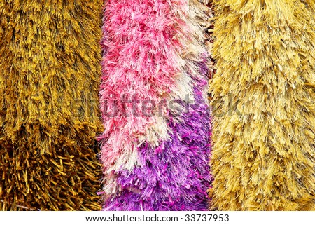 Three colorful and shaggy car wash brushes