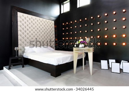 Interior of dark style bedroom with upholster wall