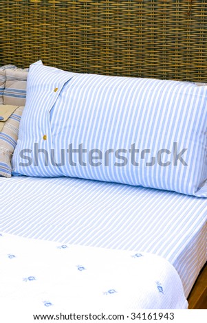 Cotton sheets with stripes on a rattan bed