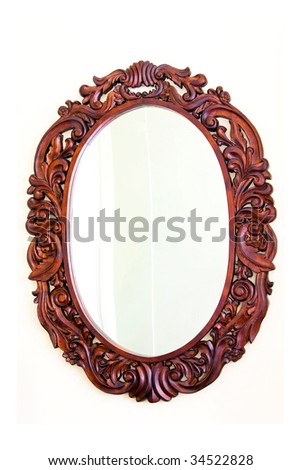 Luxurious woodwork oval mirror at white wall