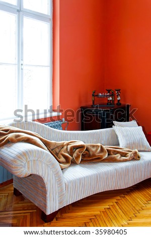 Orange living room corner with retro sofa