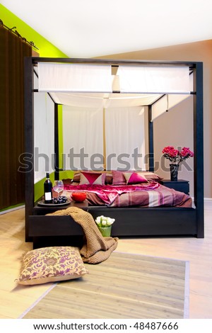 Interior of bedroom with big canopy bed
