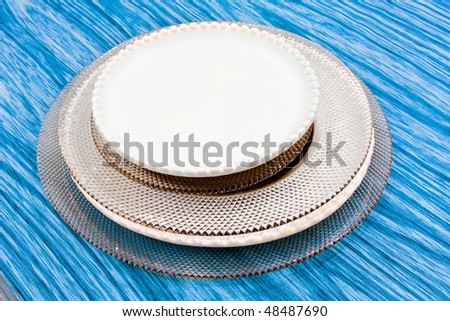 Porcelain and glass dishes at blue table cloth