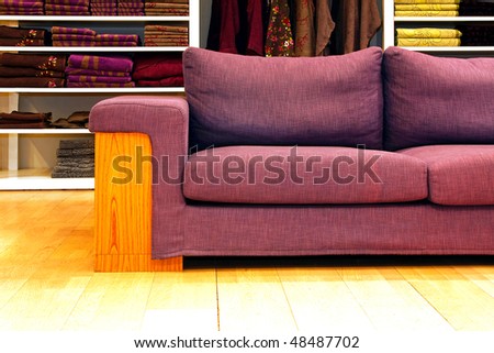 Purple sofa in front of big wardrobe