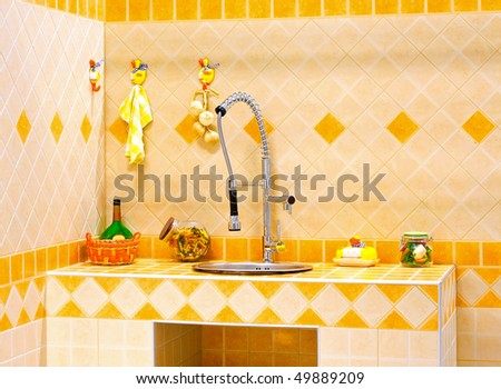 Kitchen counter and sink with orange tiles