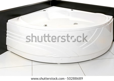 Big bathtub with hydro massage in bathroom corner