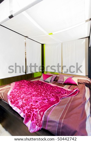 Interior of bedroom with big canopy bed