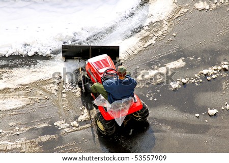 Man cleaning the road covered in snow
