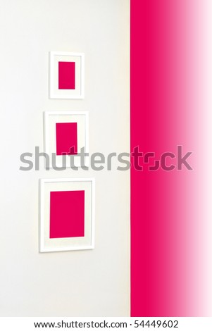 Corner of a room with frames on a wall