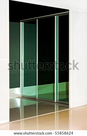 Mirrored wardrobe sliding door with reflection of the background