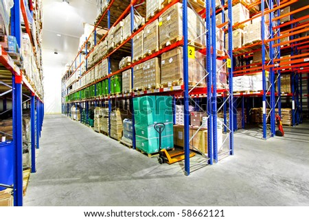 Shelves with goods in big industrial warehouse