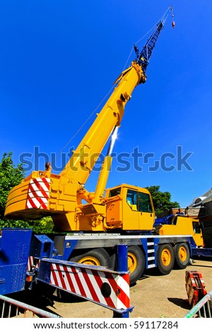 Big and yellow construction crane for heavy lifting