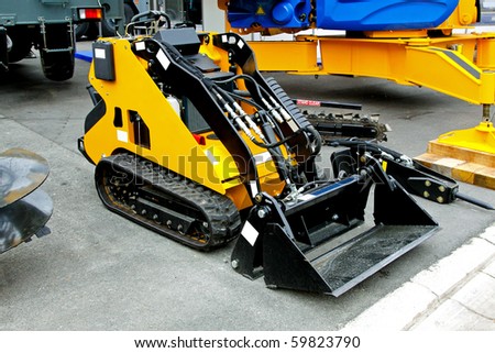 Small digger with tracks used in construction industry