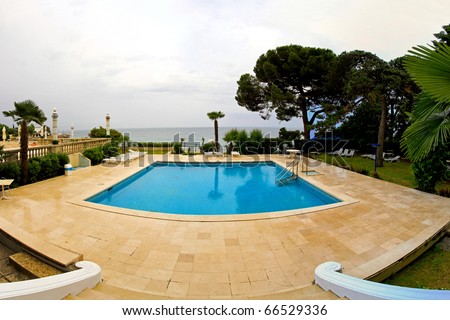 Outdoor swimming pool in courtyard of luxury mansion