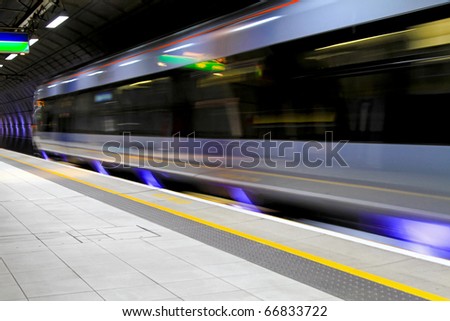 Modern speed train moving through underground station