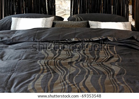 Black cotton sheets with geometric pattern design in bed