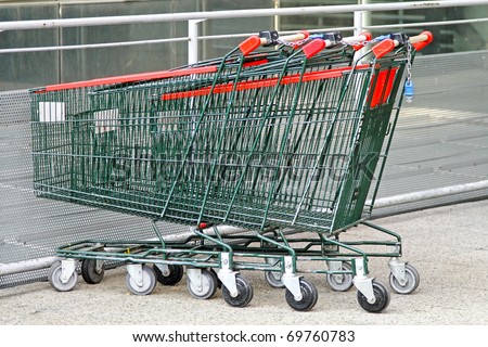 Several empty shopping carts at supermarket parking