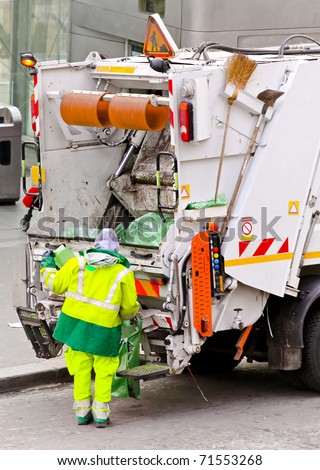 Garbage man at work at dump truck