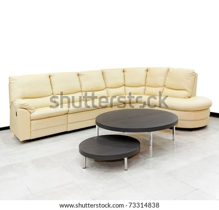 Beige leather settee in corner of living room