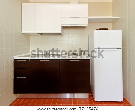 Kitchenette with all appliances in small apartment