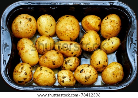 Prepared small potatoes in plastic microwave pot