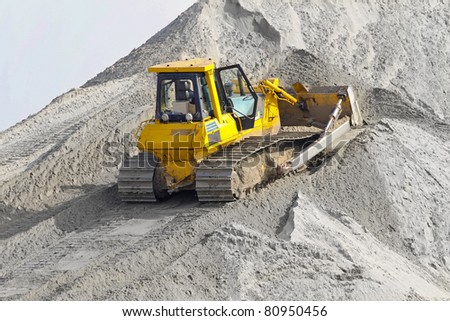 Bulldozer with track move sand at construction site