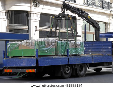 Large delivery truck with crane for heavy goods