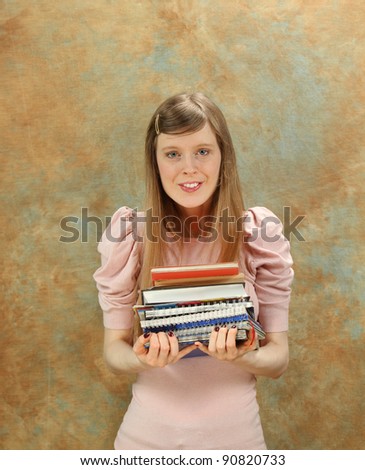 Young woman student with books in hands