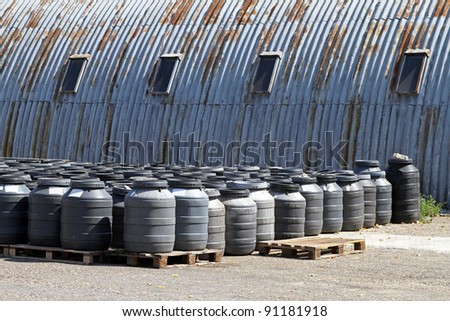 Industrial waiste in plastic barrels near warehouse
