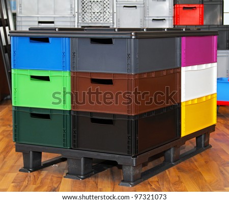 Color plastic crates and boxes at transportation pallet