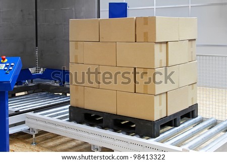 Cardboard boxes at transport pallet package machine