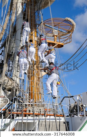 Young sailors of a ship school, climbing the masts.